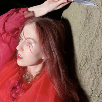 Single Review: "FINISH LINE" by Iri Antler

Sonic Landscape: Avant-Garde Dark Pop, Industrial Electronic, Cinematic Art-Pop

Vibe: Intense, Grinding, Unsettling, and Intricately Textured
The Sonic Landscape: An Industrial, Björk-esque Masterpiece

Hamburg-based female producer and German Songwriting Award nominee Iri Antler delivers an absolute tour de force of sound design with her heavy, avant-garde dark pop single, "FINISH LINE." Functioning as a relentless sonic metaphor for the crushing modern "daily grind," the track carries an undeniable cinematic intensity that immediately grips the listener.

From the opening seconds, the production reveals a masterclass in textures and electronic "ear candy." Built around the brilliant, unconventional sample of a half-broken kitchen coffee machine, the song opens with a delicate, lullaby-like melody paired with whispered dialogue. However, this deceptive calm quickly gives way to a grinding, industrial-inspired soundscape. The track features exceptionally intense percussion that hammers with mechanical precision, anchored by deep, monstrous bass synth programming. The sheer sonic weight, eerie atmosphere, and experimental sound design strongly evoke the avant-garde boldness of Björk, pushing dark pop into thrilling, uncharted territory.
The Narrative: From Streets to Award-Nominated Artistry

Iri Antler’s journey as a completely self-taught, DIY artist shines through every layer of this release. Transitioning from years of busking on Hamburg’s Reeperbahn to mastering production on an iPad, her resourcefulness is staggering. Every element of "FINISH LINE" feels deeply personal and meticulously crafted, balancing raw, unfiltered emotion with high-concept art.

The track's intense, brooding energy seamlessly pairs with its visual counterpart—a DIY, Little Red Riding Hood-inspired horror music video shot entirely on an iPhone with handmade costumes. This visual and auditory synergy reinforces the song’s dark, fairytale-turned-nightmare aesthetic, cementing Antler’s identity as a visionary auteur who commands full control over her sound, visuals, and story.
The Final Verdict

"FINISH LINE" is a staggering achievement in independent electronic music. By blending heavy industrial percussion, flawless bass synth programming, and eerie cinematic textures, Iri Antler has created an intensely captivating piece of dark pop. It is a bold, uncompromising anthem that announces the arrival of a major creative force in the international avant-garde scene.